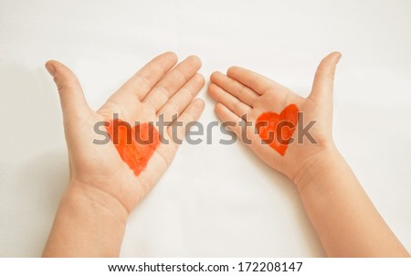 Hands of mother and child painted with red hearts concept of love Hands of mother and child painted with red hearts concept of love
