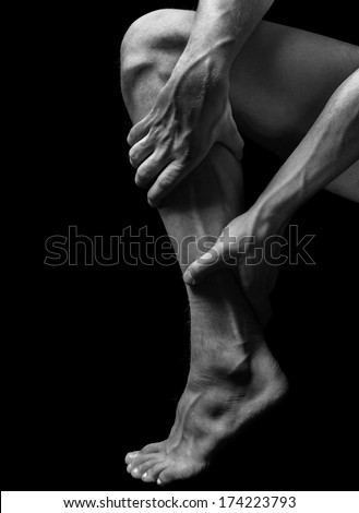 Acute pain in the male calf muscle, black and white image