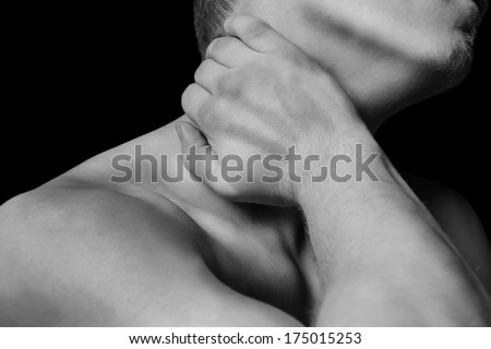 Unrecognizable man holds neck, pain in the neck, side view