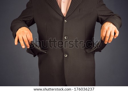 Man in a suit with pockets turned inside out. concept of crisis