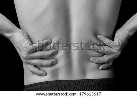 Acute pain in a male lower back, black and white image