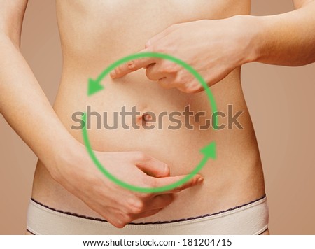 Woman points to the abdomen, arrows on the stomach, concept of comfortable digestive system