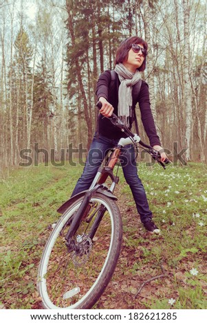 Woman on a bicycle in the forest