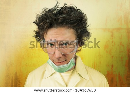 Portrait of a male mad scientist on the background of rusty metal
