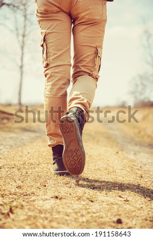 Traveler legs, woman is walking on the path, face is not visible