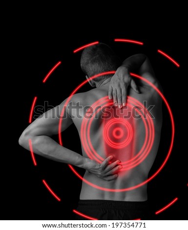 Man is touching the back, concept of pain in the spine, monochrome image, pain area of red color