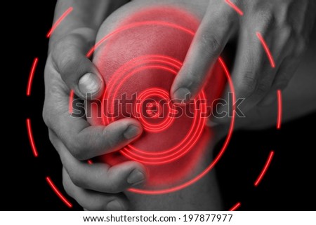 The man is touching the knee joint due to acute pain, pain area of red color