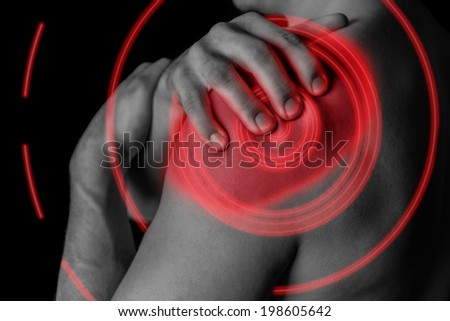 Man compresses his shoulder, pain in the shoulder, black and white image, pain area of red color
