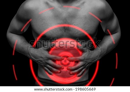 Unrecognizable man compresses the abdomen due to pain, monochrome image, pain area of red color