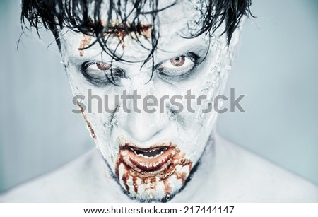 Scary zombie man in blood on white background, Halloween or horror theme
