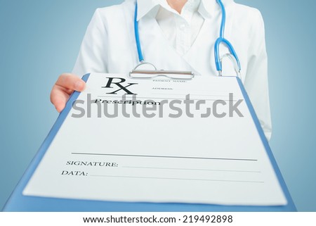 Unrecognizable female doctor gives clipboard with prescription paper