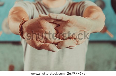 Man warming up his hands before climbing indoor