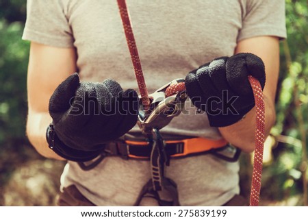GUAMKA, RUSSIA, 03 May 2015: Man ensures the safety of climber man with ropes and device grigri, 03 May 2015