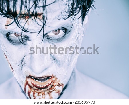 Portrait of scary zombie man in blood, Halloween or horror theme. Space for text in right part of the image