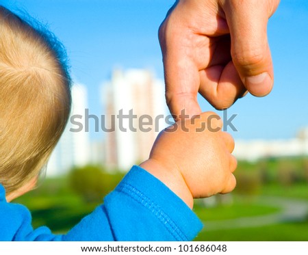 trust family hands of child son and father on wheat field nature outdoor
