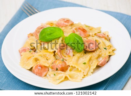 Farfalle pasta with sausage and cream sauce with basil