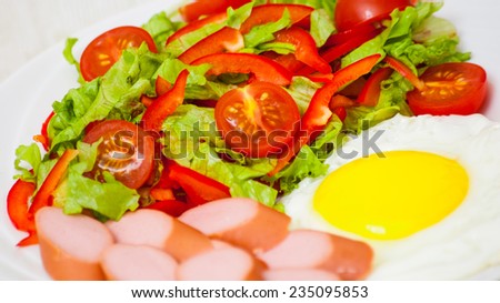 breakfast. salad, egg and sausage
