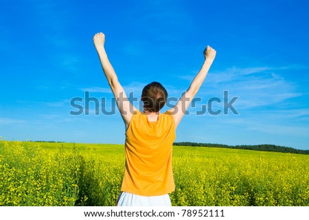 man with his hands up on the field