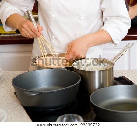 Kitchen on Professional Chef Hands With Kitchen Utensils Whisk And Pan   Stock