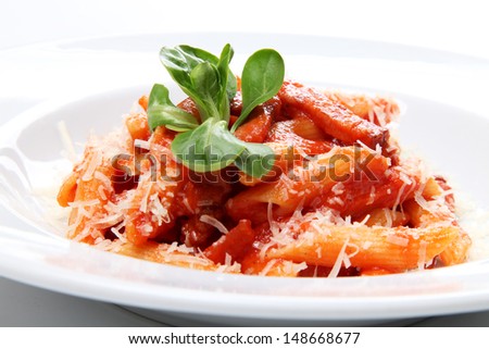 Macaroni pasta with bolognese sauce and parmesan cheese on a white plate isolated