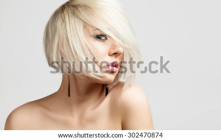 Portrait of a fashion blonde with short hair and bare shoulders
