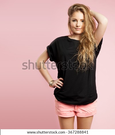Blonde girl with beautiful curly hair into a blank black T-shirt