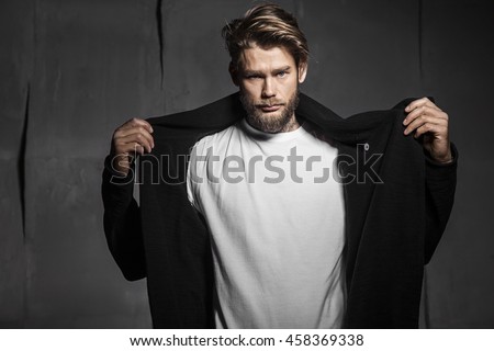 Baerded man in white t-shirt on grey background