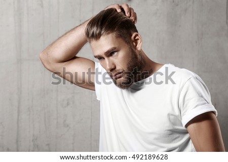 Handsome bearded man in a blank white t-shirt with stylish hair