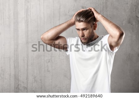 Handsome bearded guy in a blank white t-shirt with stylish hair