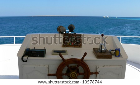 Behind the wheel - captain\'s bridge on a boat