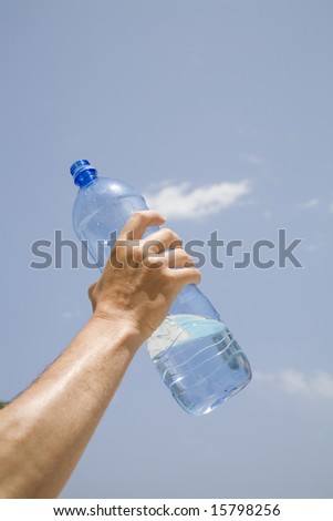 A bottle of Mineral water in hand