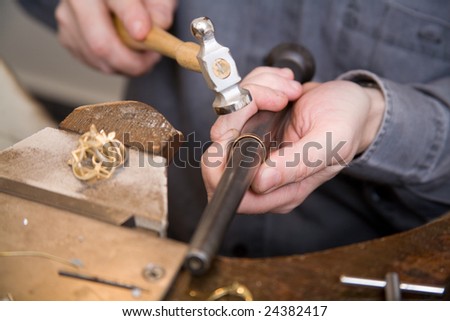 Goldsmith work in process with hammer