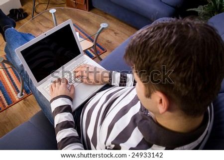 Young man work with computer at home