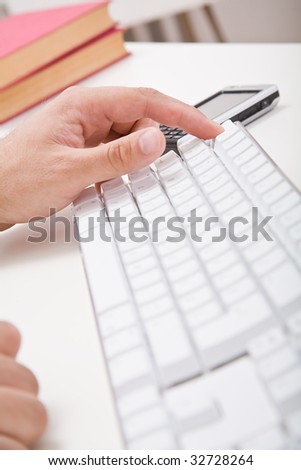 Hands, keyboard and hands on desktop