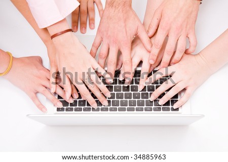 Lot of hands with grey laptop computer on desk