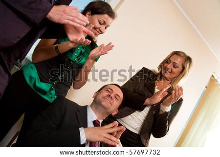 Business man making a presentation, women applauding