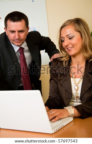 Business man and woman working on laptop in the office