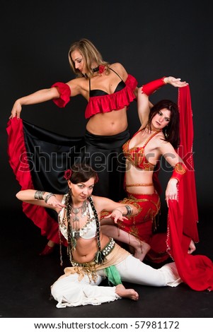Group of three  women perfoming exotic belly dance