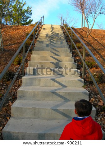 boy climbing steps at park