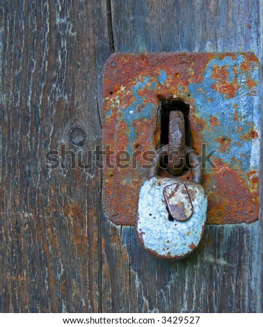rusty padlock on wooden background