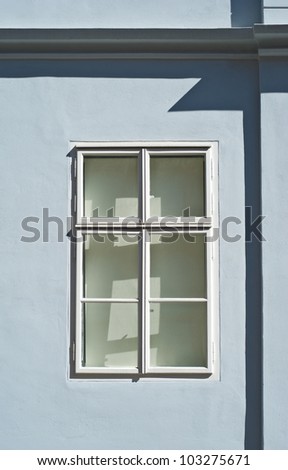 white wooden window at light blue colored house