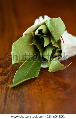 laurel leaves (Laurus nobilis) on wooden background