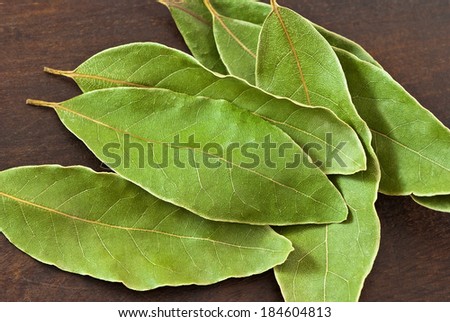 dry laurel leaves (Laurus nobilis) on wooden background