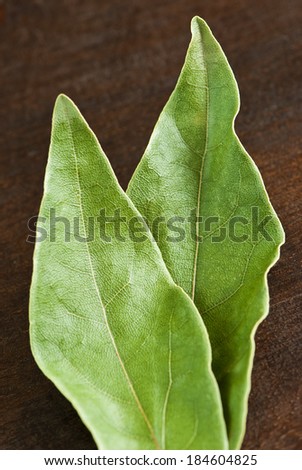 dry laurel leaves (Laurus nobilis) on wooden background