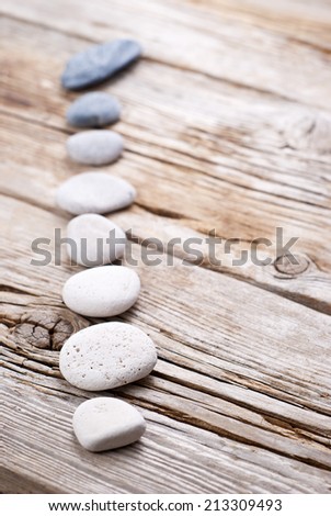 white and grey pebbles on old wooden surface