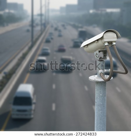 CCTV camera with blur traffic road background