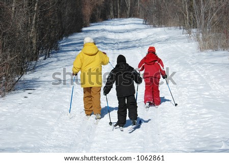 family skiing on trail