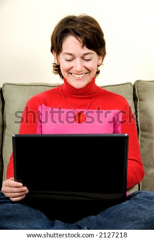 woman with laptop on the couch on her lap