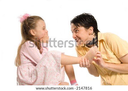 daughter and mom playing tickle on the feet