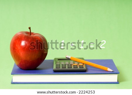 blue book and red apple and pencil and calculator